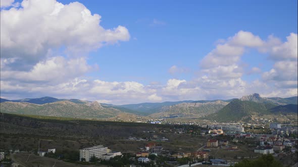 Mountains Against the Blue Sky with White Clouds. Cirrus Clouds Run Across the Blue Sky