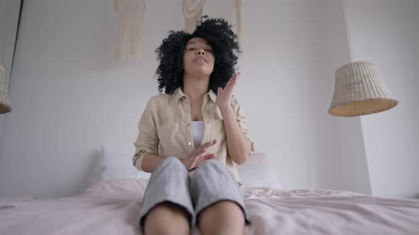 Front View of Serious African American Woman Rejecting Idea Online Sitting in Comfortable Home