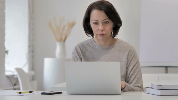 Old Senior Woman Leaving After Completing Work on Laptop