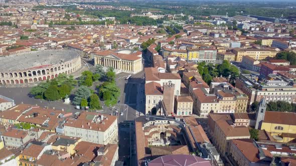 Verona,Italy:Flying over historic city center with typical apartment rooftops Roman Colosseum Arena