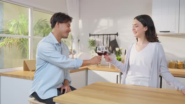 Asian young new marriage couple spend time together in kitchen at home.