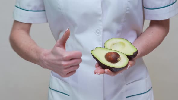 Nutritionist Doctor Healthy Lifestyle Concept - Holding Organic Avocado