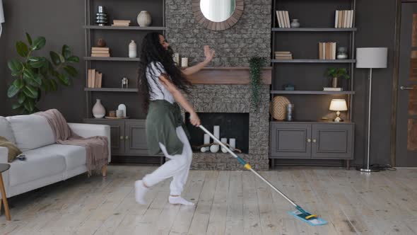 Active Joyful Young Woman Housewife Washes Floor with Mop in Living Room Cleans at Home Happy