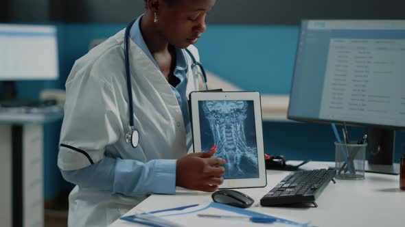 Close Up of Medic Pointing at Tablet Display with Radiography