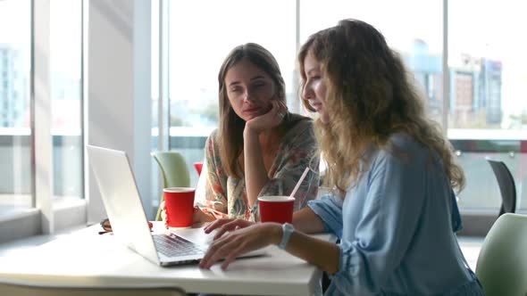 Designers Working in Cafe with Laptop