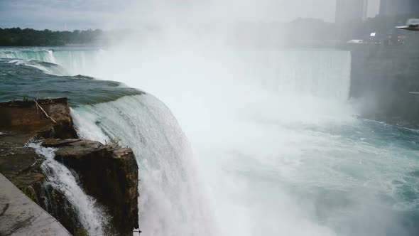 Amazing Close-up Shot of Bird Flying By Raging Water Stream Rushing Down a Rock at Epic Niagara