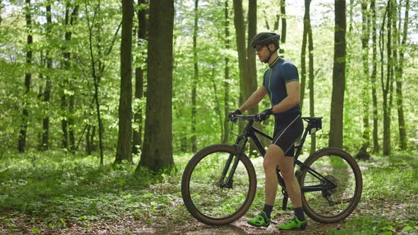 The Cyclist is Walking Next to the Bike