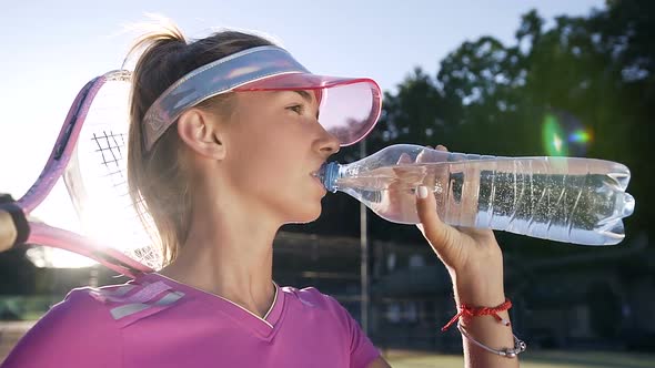 Fit Young Woman Drinking Water from Bottle