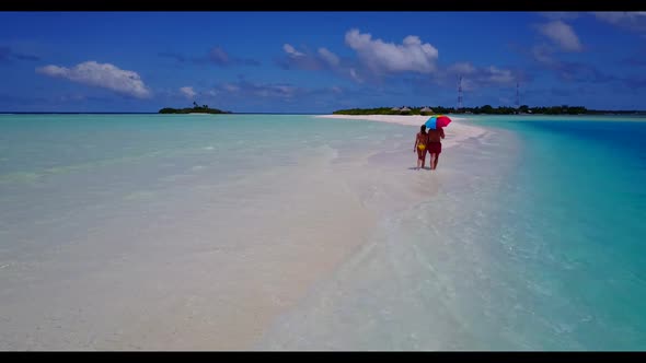 Teenage lovers suntan on beautiful bay beach journey by blue ocean and white sandy background of the