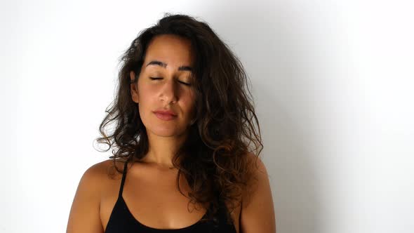 A beautiful mixed-race woman with dark hair smiling and looking tenderly at the camera.