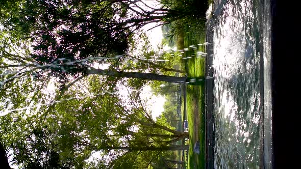 Vertical Slow Motion Tilt Up, Waterfall fountain flowing in California park