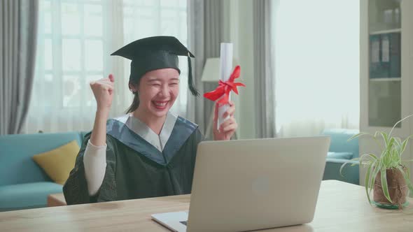 Asian Woman Celebrating With University Certificate To The Family During An Online Video Call