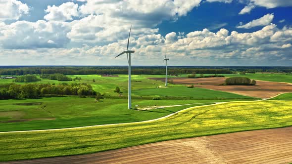 Amazing yellow rape fields and wind turbine. Poland agriculture. alt