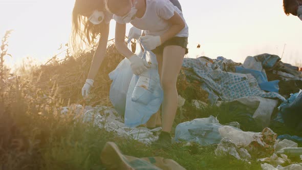 Close Up Shot of Group of Eco Volunteers Cleaning Up Area of Dump Near the Field Slow Motion