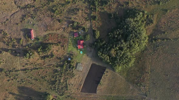 aerial shot of South African farm landscape with red roofed house and trees