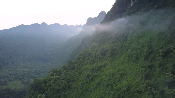 Foggy Haze Among High Steep Mountain Ranges Under Gray Sky