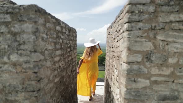 Girl In Yellow Dress Walking On Mayan Ruin Temple in Belize