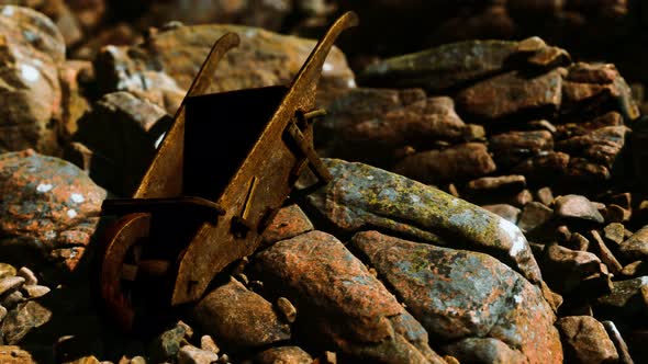 Abandoned Wooden Mine Wheelbarrow on Rocks