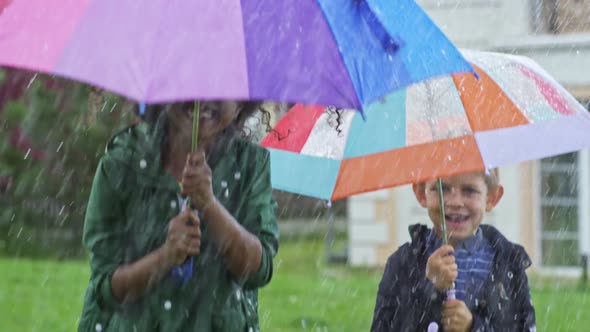 Happy Children Jumping in Rain