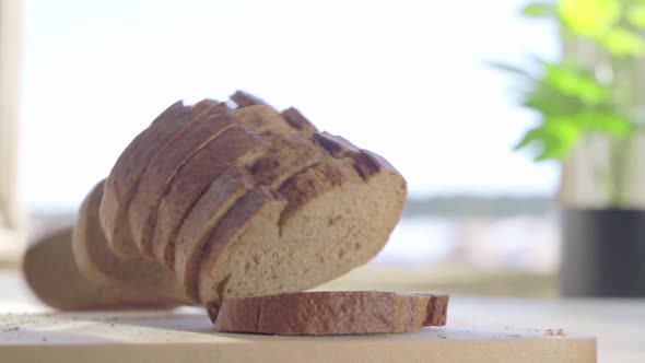 Sliced White Bread Falling on the Table in Slow Motion