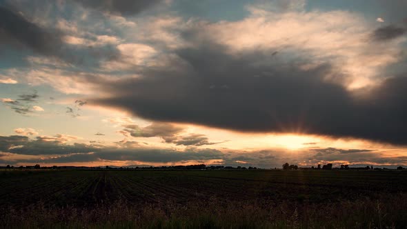 Time lapse of colorful sunset over farm field in Idaho