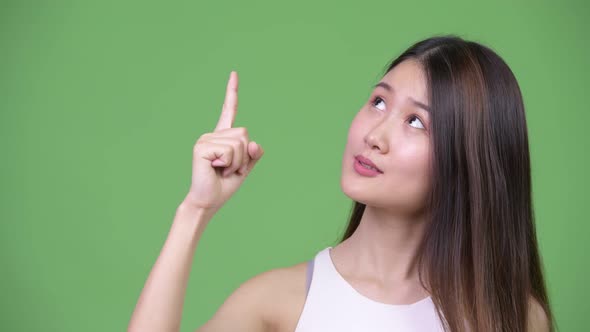 Young Beautiful Asian Businesswoman Pointing Up