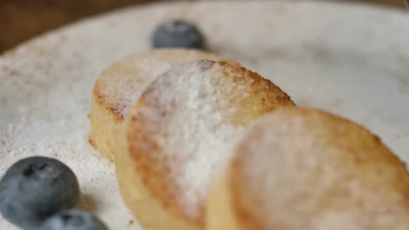 Delicious Cheese Pancakes Cowered with Sugar Powder on Plate