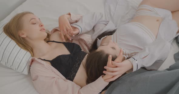 Two lesbians in bed The girl is touching a girl LGBT Bisexual Lesbian concept Love