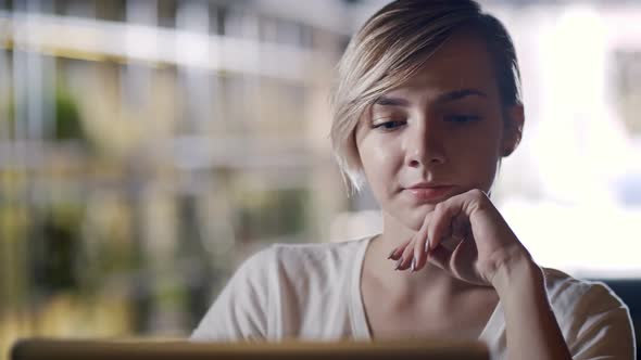 Woman with Short Hair Working on Laptop