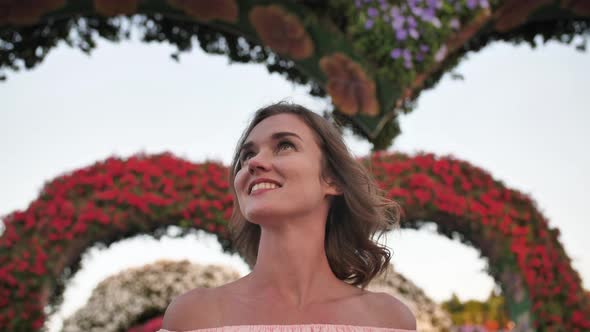 A Girl Walks Through a Fabulous Park in Dubai