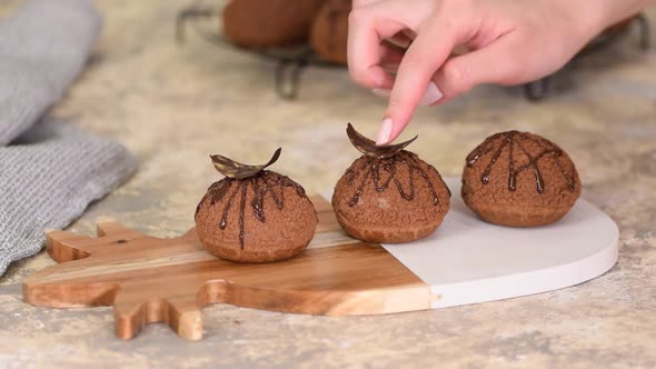 Decorating Choux Au Craquelin with Chocolate. Delicious French Dessert.