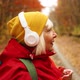Happy 40s Woman in Colorful Yellow Clothing Putting on Wireless Headphones Listen Music While - VideoHive Item for Sale