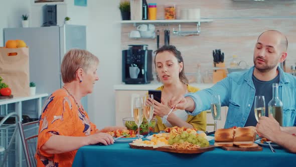 Woman Using Phone During Dinner