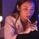 Young Asian beautiful woman enjoy using smartphone- tablet   in bedroom at night time. - VideoHive Item for Sale