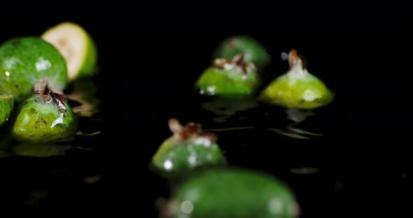 The Feijoa Slices Fall on the Water with Splashes. 