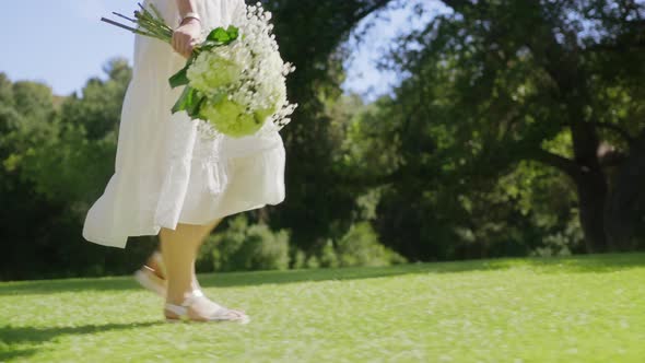 Romantic Woman Walking in Green Park at Beautiful Forest Bokeh Background RED