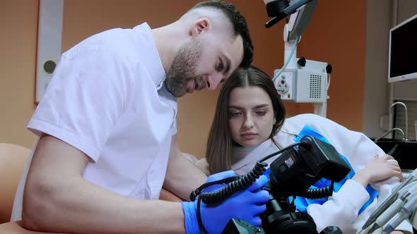 The dentist shows the patient a picture of the result of treatment. Satisfied patient.