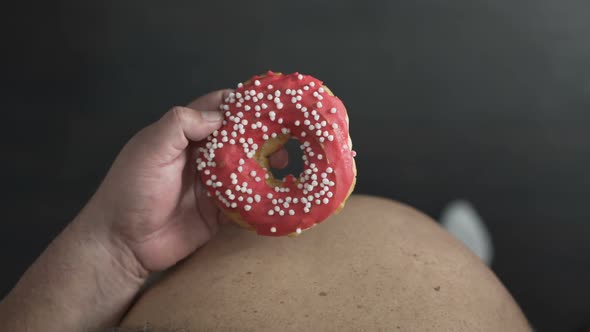 Top View Of Overweight Person Eating High-calorie Donut With Glaze, Obesity