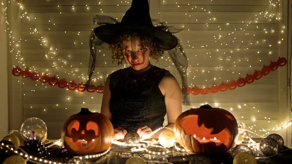 Portrait of a Teenage Girl Dressed As a Witch with Scary Makeup on Her Face