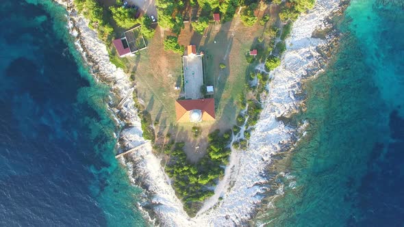 Flying over lighthouse, Croatia with a red tiled roof