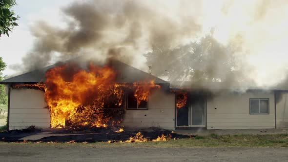 House on fire burning in slow motion