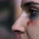Close-up of a tear on the face of a young woman with a trauma from violence - VideoHive Item for Sale