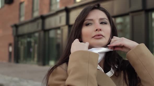 Nice Brunette Girl Takes Off a White Virus Mask From Her Face and Breathes in the Air