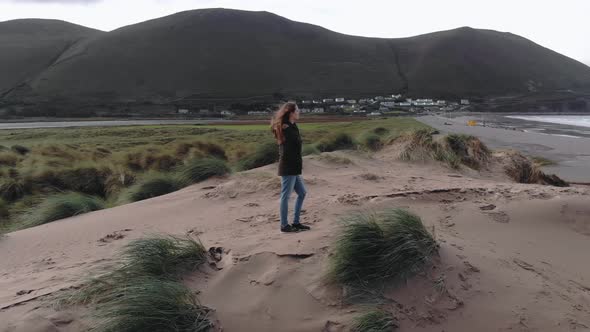 Drone Flight Around a Girl Viewing Over the Atlantic Ocean