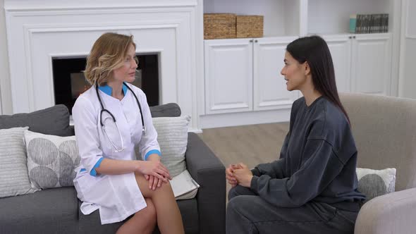 Young Woman Doctor Supporting Patient During Consultation at Home