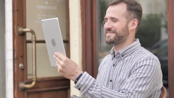 Online Video Chat on Tablet By Young Man