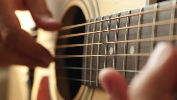 The Musician Plays a Melody on a Yellow Acoustic Guitar, Close-up