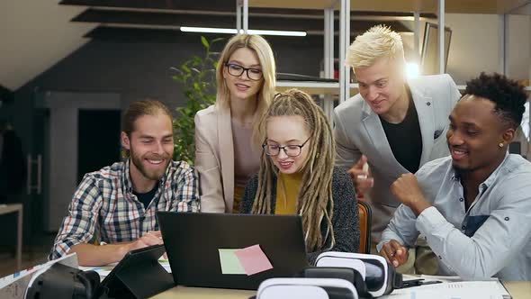 Multiracial Colleagues which Talking about Joint Business Project in front of Computer Screen