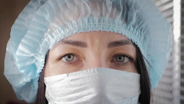 Tired Look of a Health Worker Wearing a Surgical Mask During a Break