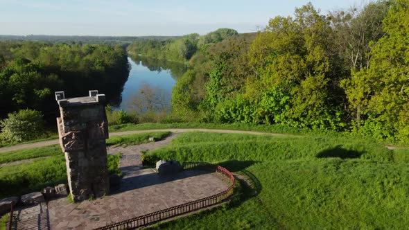 Aerial Drone View Flight Over Glade Bright Green Grass and Stone Old Tower